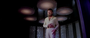 Movie still from “Star Trek: The Motion Picture” (1979), directed by Robert Wise – A man with a long beard standing in front of a wall; Medium shot, Low angle