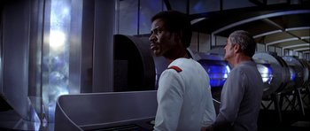 Movie still from “Star Trek: The Motion Picture” (1979), directed by Robert Wise – A man standing in front of a computer screen; Medium shot, Over the shoulder angle