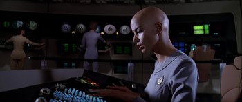 Movie still from “Star Trek: The Motion Picture” (1979), directed by Robert Wise – A woman in a grey uniform is looking at a computer screen; Medium shot, Low angle