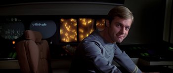 Movie still from “Star Trek: The Motion Picture” (1979), directed by Robert Wise – A man sitting in front of a wall with lights on it; Close Up shot, Low angle