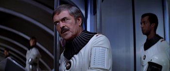 Movie still from “Star Trek: The Motion Picture” (1979), directed by Robert Wise – A person wearing a white suit; Close Up shot, Over the shoulder angle