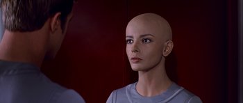 Movie still from “Star Trek: The Motion Picture” (1979), directed by Robert Wise – A woman with a bald head is looking into a mirror; Close Up shot, Over the shoulder angle