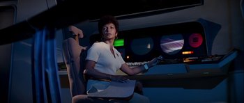 Movie still from “Star Trek: The Motion Picture” (1979), directed by Robert Wise – A woman sitting in a chair holding a remote control; Medium shot, Low angle