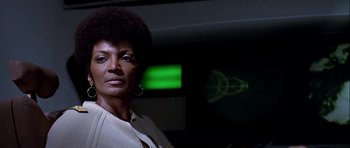 Movie still from “Star Trek: The Motion Picture” (1979), directed by Robert Wise – A woman in a white shirt is in front of a green screen; Close Up shot, Low angle