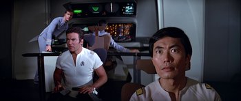 Movie still from “Star Trek: The Motion Picture” (1979), directed by Robert Wise – A group of men sitting in a room; Medium shot, Over the shoulder angle