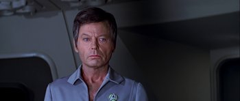 Movie still from “Star Trek: The Motion Picture” (1979), directed by Robert Wise – A person wearing a blue shirt; Close Up shot, Over the shoulder angle