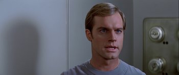 Movie still from “Star Trek: The Motion Picture” (1979), directed by Robert Wise – A person wearing a gray t - shirt; Close Up shot, Over the shoulder angle