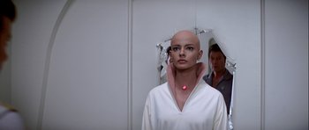 Movie still from “Star Trek: The Motion Picture” (1979), directed by Robert Wise – A woman with a bald head is standing in front of a mirror; Close Up shot, Low angle