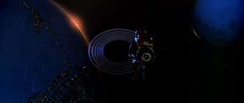 Movie still from “Star Trek: The Motion Picture” (1979), directed by Robert Wise – An image of a man in a space suit holding a camera; Extreme Wide shot, Overhead angle