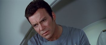 Movie still from “Star Trek: The Motion Picture” (1979), directed by Robert Wise – A man's face in a blue shirt; Close Up shot, Over the shoulder angle