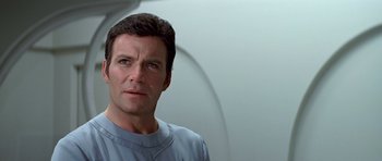 Movie still from “Star Trek: The Motion Picture” (1979), directed by Robert Wise – A person wearing a blue shirt; Close Up shot, Over the shoulder angle