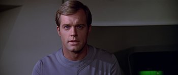 Movie still from “Star Trek: The Motion Picture” (1979), directed by Robert Wise – A person wearing a t - shirt; Close Up shot, Over the shoulder angle