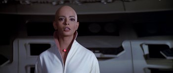 Movie still from “Star Trek: The Motion Picture” (1979), directed by Robert Wise – A woman with a bald head wearing a white shirt; Close Up shot, Low angle