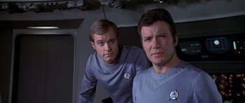 Movie still from “Star Trek: The Motion Picture” (1979), directed by Robert Wise – Two men are standing next to each other; Medium shot, Over the shoulder angle