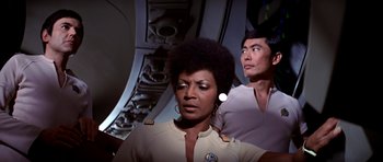 Movie still from “Star Trek: The Motion Picture” (1979), directed by Robert Wise – A woman and a man are standing next to each other; Medium shot, Over the shoulder angle