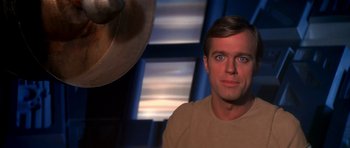 Movie still from “Star Trek: The Motion Picture” (1979), directed by Robert Wise – A person wearing a tan t - shirt; Close Up shot, Over the shoulder angle