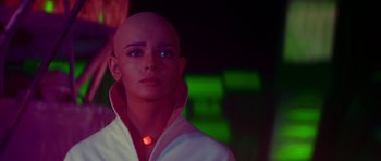 Movie still from “Star Trek: The Motion Picture” (1979), directed by Robert Wise – A bald woman with a red light around her neck; Close Up shot, Low angle