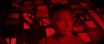Movie still from “Star Trek: The Motion Picture” (1979), directed by Robert Wise – A man in a red room looking at the camera; Close Up shot, Over the shoulder angle