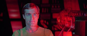 Movie still from “Star Trek: The Motion Picture” (1979), directed by Robert Wise – A man in a yellow shirt is in a room; Close Up shot, Low angle