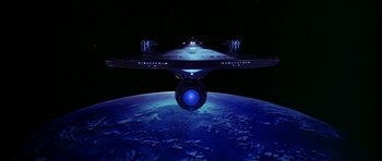 Movie still from “Star Trek: The Motion Picture” (1979), directed by Robert Wise – A space ship is flying over the earth at night time; Extreme Wide shot, Low angle