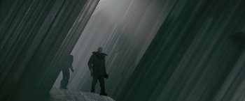 Movie still from “Superman Returns” (2006), directed by Bryan Singer – A man standing on top of a building in the fog; Wide shot, Low angle