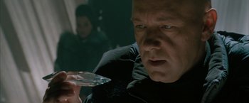 Movie still from “Superman Returns” (2006), directed by Bryan Singer – A man that is holding a crystal in his hand; Close Up shot, Over the shoulder angle