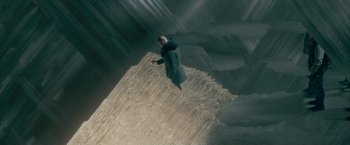 Movie still from “Superman Returns” (2006), directed by Bryan Singer – A man standing on top of a rock formation; Extreme Wide shot, High angle