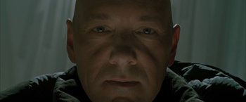 Movie still from “Superman Returns” (2006), directed by Bryan Singer – A man's face in the dark; Extreme Close Up shot, Overhead angle