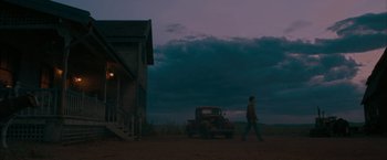 Movie still from “Superman Returns” (2006), directed by Bryan Singer – A man walking in front of an old truck in a field; Extreme Wide shot, Low angle