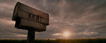 Movie still from “Superman Returns” (2006), directed by Bryan Singer – The sun is setting over a grassy field; Extreme Wide shot, Low angle