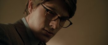 Movie still from “Superman Returns” (2006), directed by Bryan Singer – A person wearing glasses; Close Up shot, Low angle