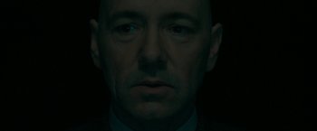 Movie still from “Superman Returns” (2006), directed by Bryan Singer – A person wearing a suit and tie; Close Up shot, Low angle