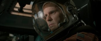 Movie still from “Superman Returns” (2006), directed by Bryan Singer – A man wearing a helmet looking into a mirror; Close Up shot, Overhead angle