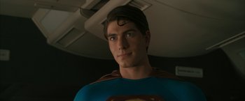 Movie still from “Superman Returns” (2006), directed by Bryan Singer – A person wearing a superman costume; Close Up shot, Over the shoulder angle