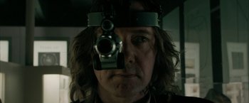 Movie still from “Superman Returns” (2006), directed by Bryan Singer – A man with a sight in his eye looking into a mirror; Close Up shot, Low angle