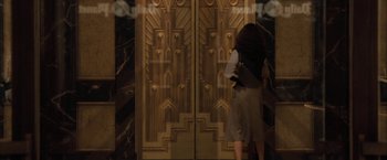 Movie still from “Superman Returns” (2006), directed by Bryan Singer – A woman standing in front of a door way; Wide shot, Low angle