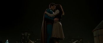 Movie still from “Superman Returns” (2006), directed by Bryan Singer – A man and a woman dressed as superman and wonder woman; Wide shot, Low angle