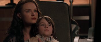 Movie still from “Superman Returns” (2006), directed by Bryan Singer – A woman and a child sitting in a chair; Close Up shot, Low angle