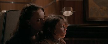 Movie still from “Superman Returns” (2006), directed by Bryan Singer – A woman is kissing a young boy on the cheek; Close Up shot, Over the shoulder angle