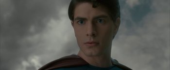 Movie still from “Superman Returns” (2006), directed by Bryan Singer – A person wearing a superman costume; Close Up shot, Over the shoulder angle
