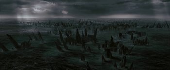 Movie still from “Superman Returns” (2006), directed by Bryan Singer – An image of an ocean with a lot of trees in the water; Extreme Wide shot, High angle