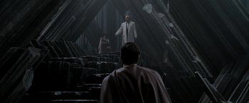 Movie still from “Superman Returns” (2006), directed by Bryan Singer – A man and a woman standing on a set of stairs; Wide shot, Over the shoulder angle