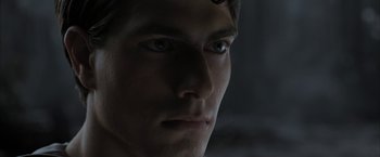 Movie still from “Superman Returns” (2006), directed by Bryan Singer – A young man's face in the dark; Close Up shot, Over the shoulder angle
