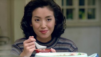 Movie still from “Eat Drink Man Woman” (1994), directed by Ang Lee – A woman sitting at a table with a bowl of food; Close Up shot, High angle