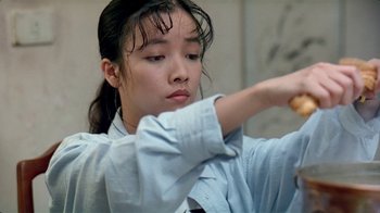 Movie still from “Eat Drink Man Woman” (1994), directed by Ang Lee – A young woman is holding a baseball bat in her hand; Close Up shot, Low angle