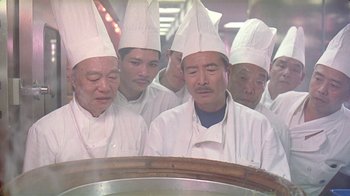 Movie still from “Eat Drink Man Woman” (1994), directed by Ang Lee – A group of people wearing chef's hats in front of a pot; Close Up shot, Low angle