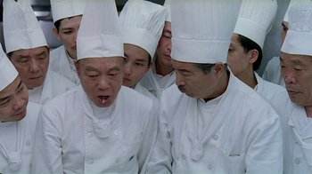Movie still from “Eat Drink Man Woman” (1994), directed by Ang Lee – A group of people wearing chef's hats and aprons; Close Up shot, High angle