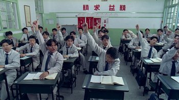 Movie still from “Eat Drink Man Woman” (1994), directed by Ang Lee – A group of people sitting at desks in a classroom; Medium shot, High angle
