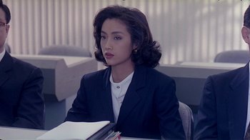 Movie still from “Eat Drink Man Woman” (1994), directed by Ang Lee – A woman sitting at a table with a book in front of her; Close Up shot, High angle