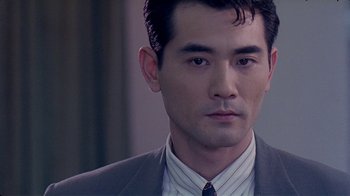 Movie still from “Eat Drink Man Woman” (1994), directed by Ang Lee – A person wearing a suit and tie; Close Up shot, Over the shoulder angle
